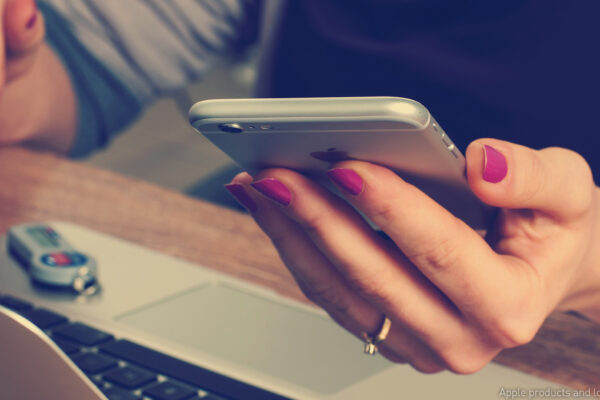 woman with cellphone and laptop