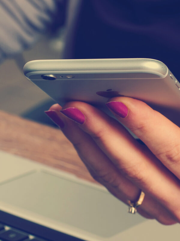 woman with cellphone and laptop