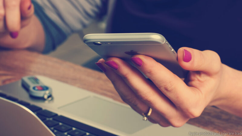 woman with cellphone and laptop