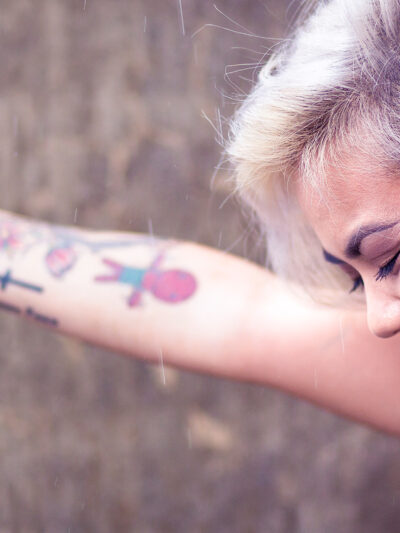 woman with tattoos smiling