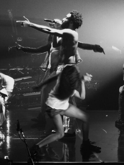 childish gambino performing "this is america" on stage, surrounded by dancers