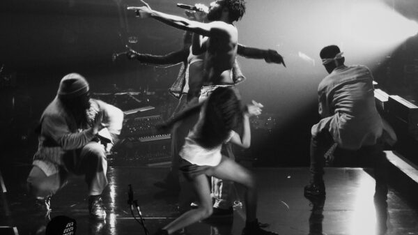 childish gambino performing "this is america" on stage, surrounded by dancers