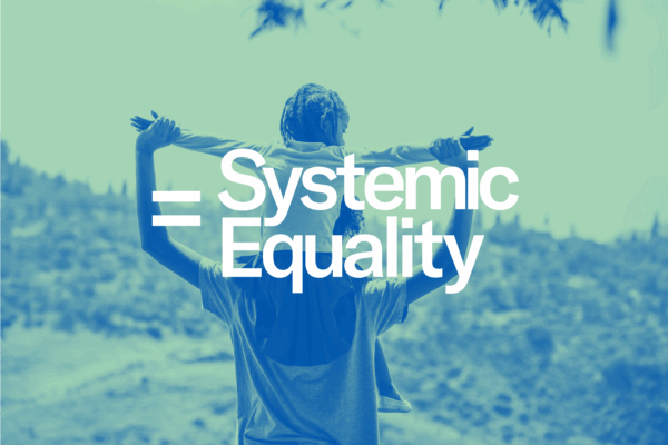 The text 'Systemic Equality' overlaid on the image of a child on the shoulders of an adult.