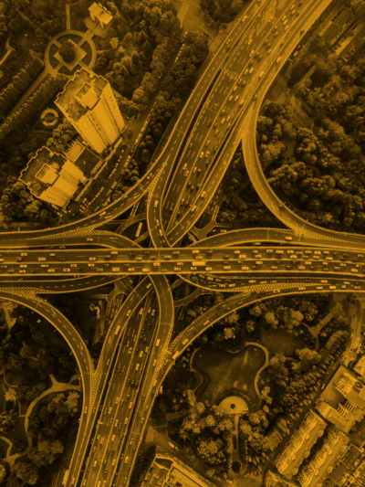 A photo of an overview of a cloverleaf interchange with heavy traffic on the roads.