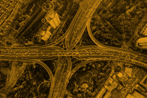 A photo of an overview of a cloverleaf interchange with heavy traffic on the roads.