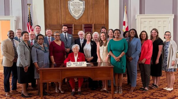 group posed with Governor Kay Ivey signing the Maternal Healthcare Act Bill Signing