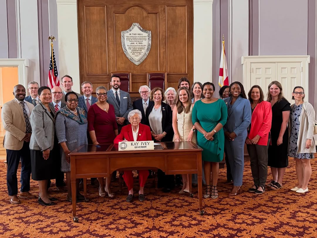 group posed with Governor Kay Ivey signing the Maternal Healthcare Act Bill Signing