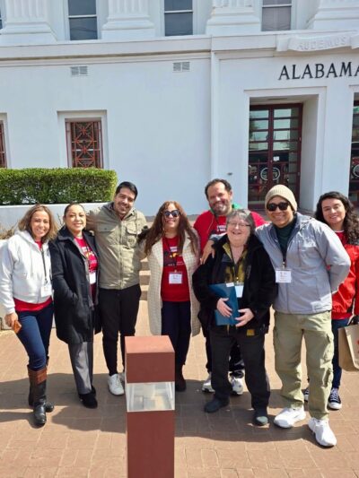 group of volunteers standing in front of the state house