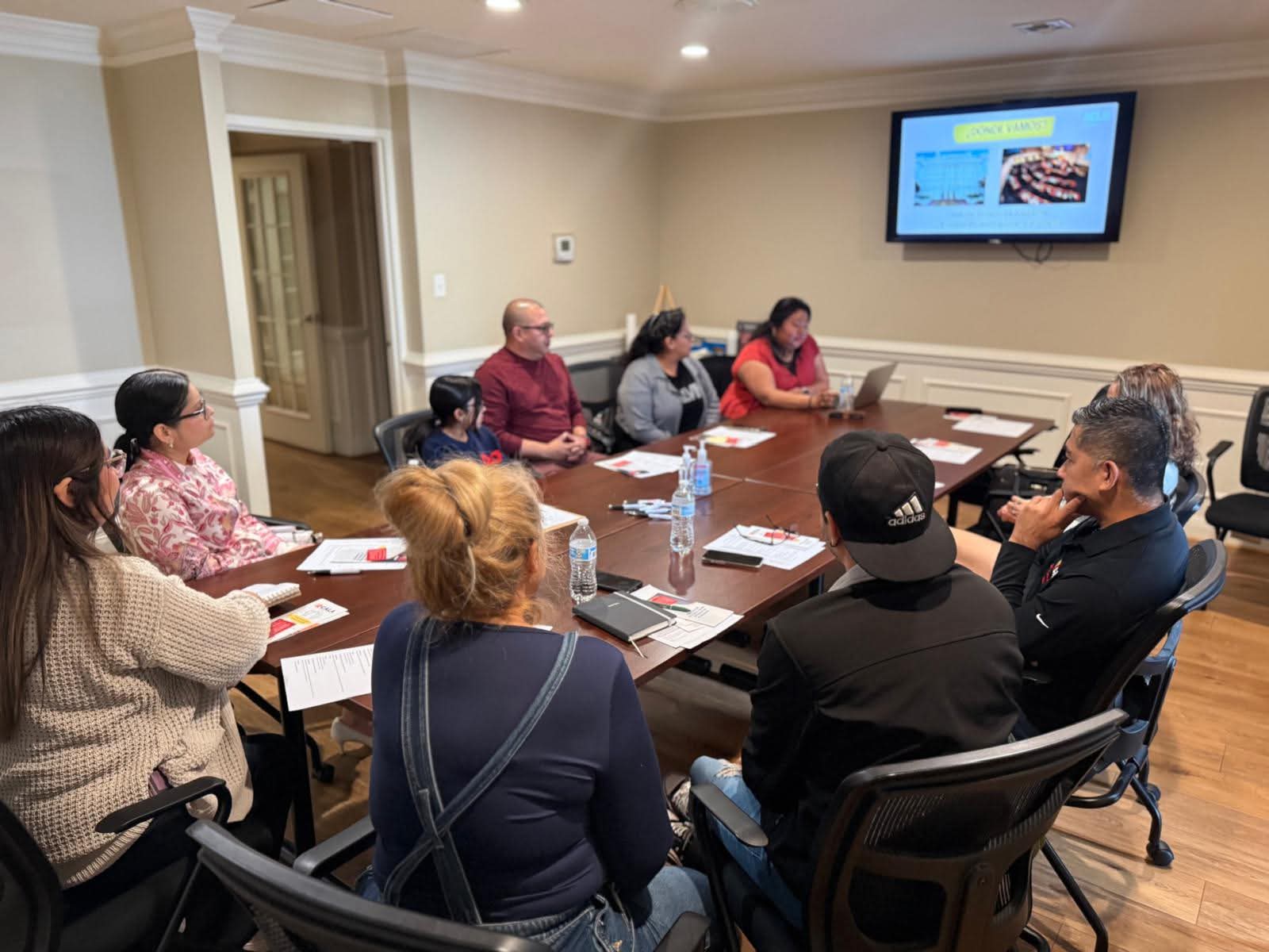 volunteers around a conference table being trained