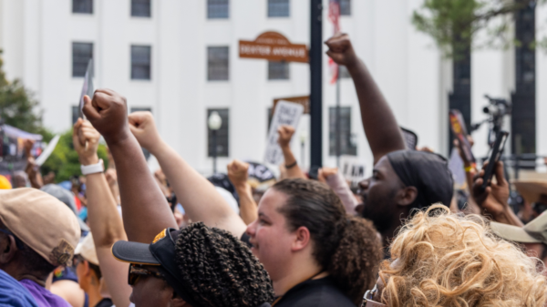 crowd with fists raised