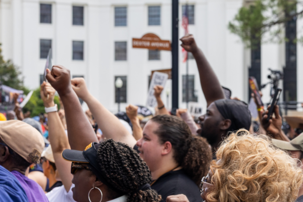 crowd with fists raised