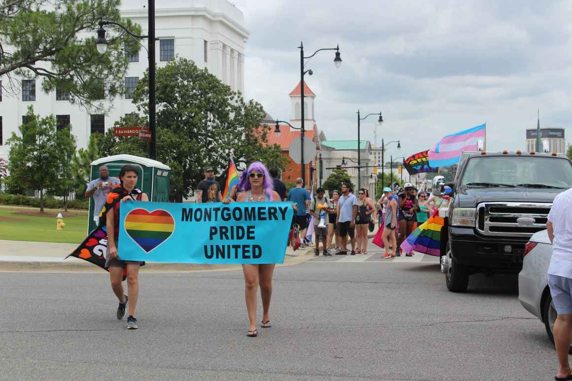 marchers with montgomery pride united banner