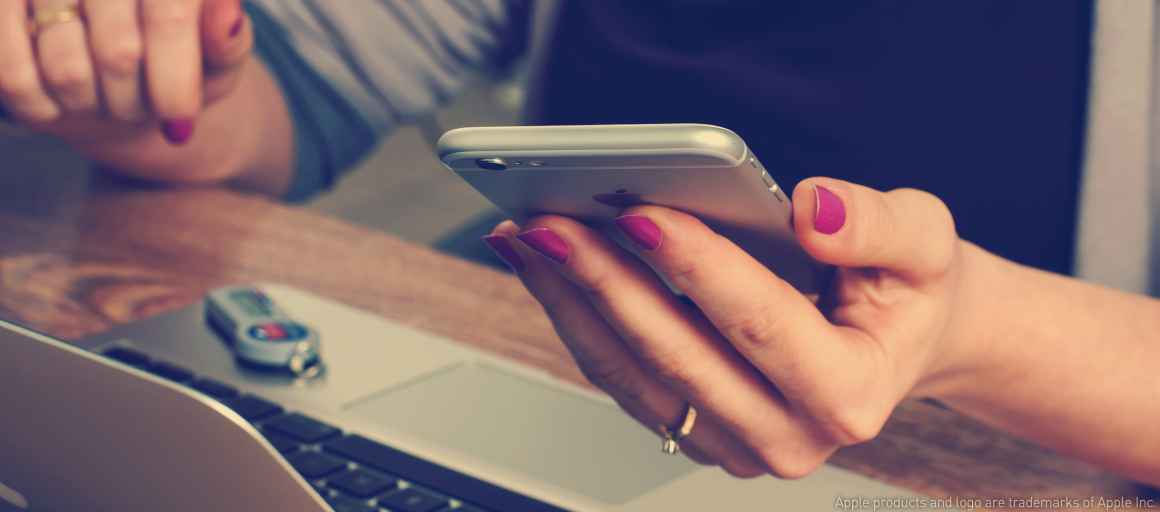 woman with cellphone and laptop