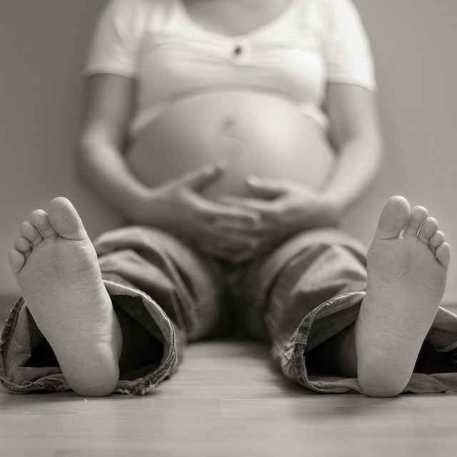 pregnant woman sitting on floor