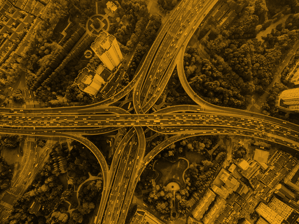 A photo of an overview of a cloverleaf interchange with heavy traffic on the roads.