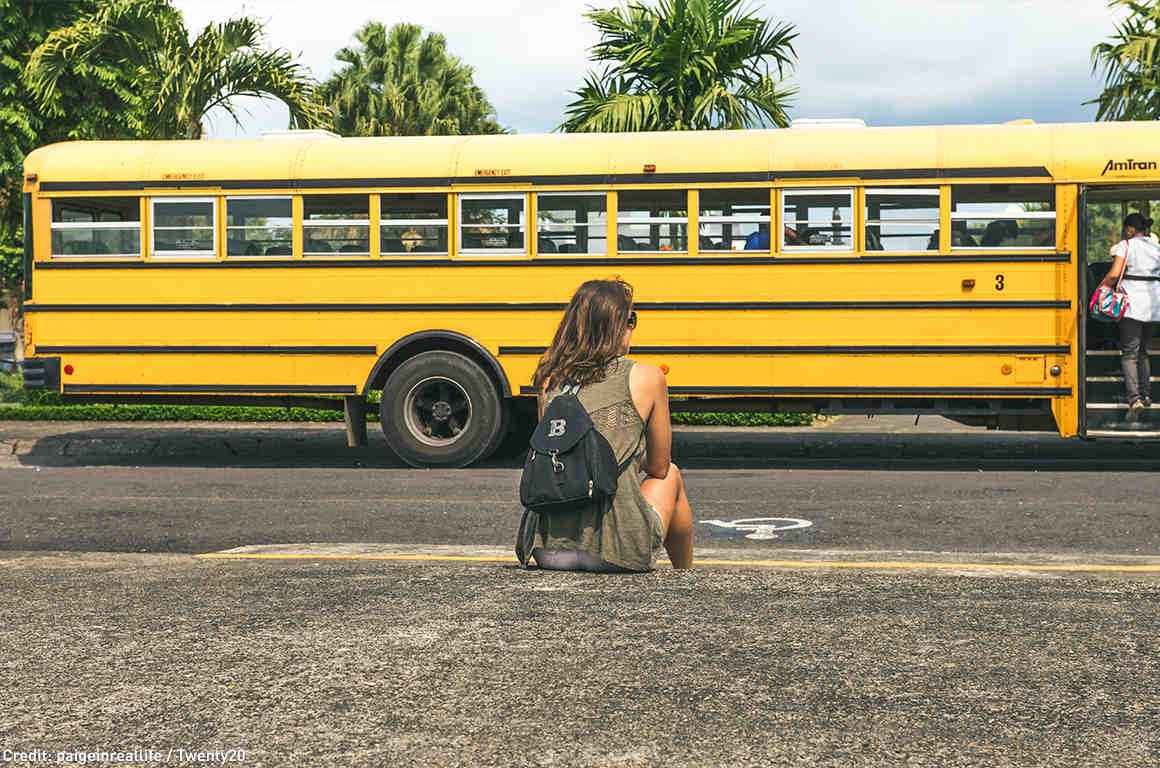 student waiting for the school bus