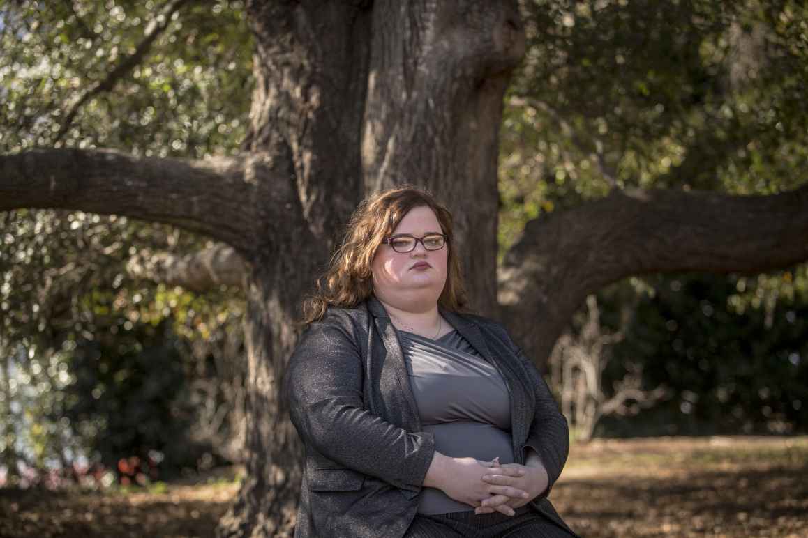 Darcy Corbitt sits by a tree