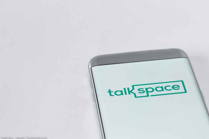 Image of Talkspace app on a smartphone on a white background.