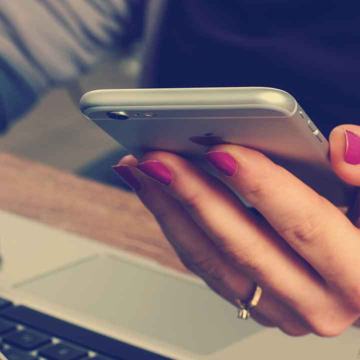 woman with cellphone and laptop