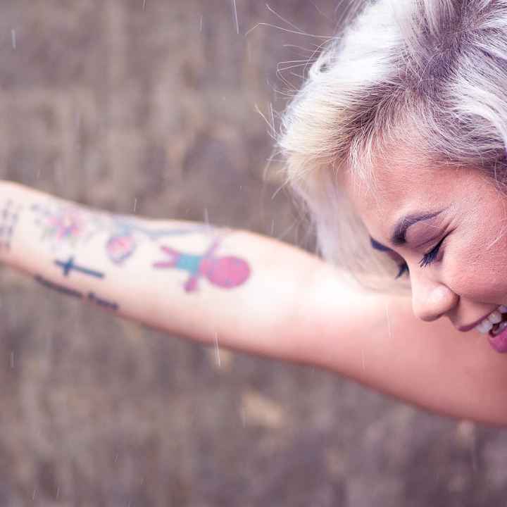 woman with tattoos smiling