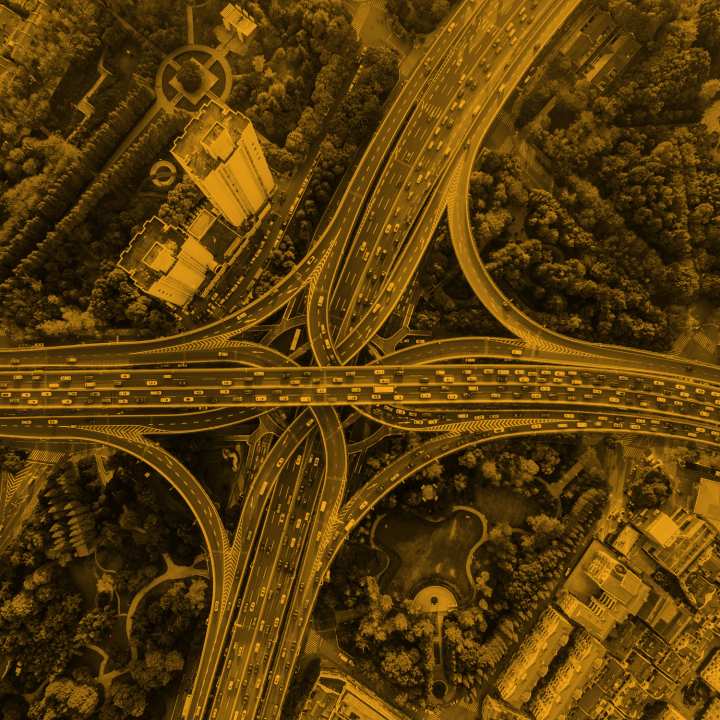 A photo of an overview of a cloverleaf interchange with heavy traffic on the roads.