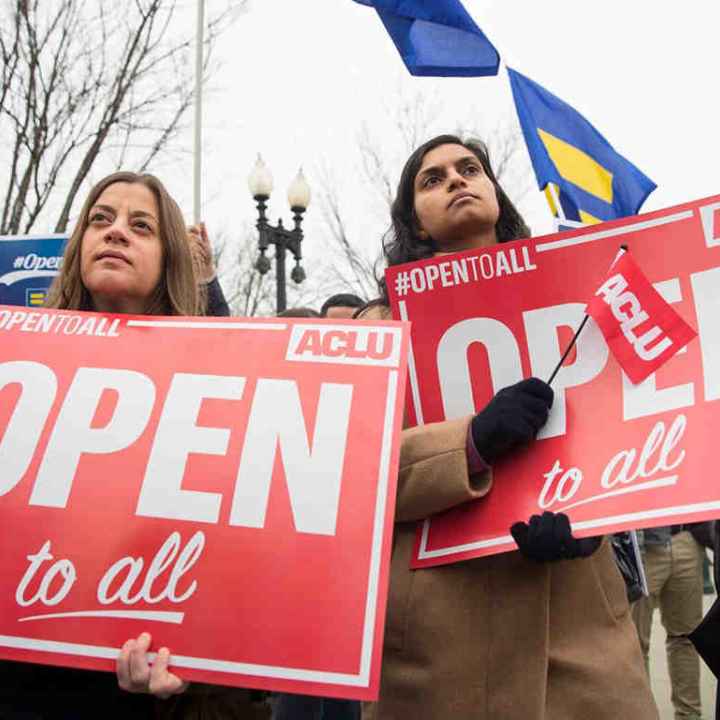 protestors with open to all signs
