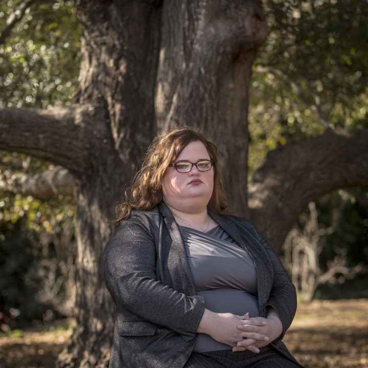 Darcy Corbitt sits by a tree